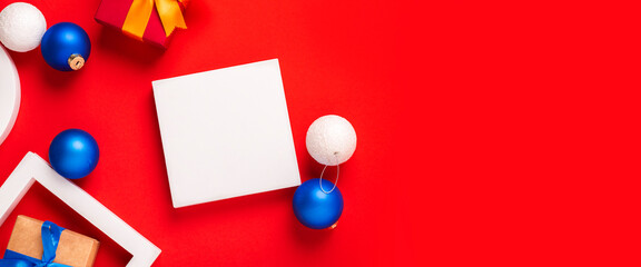 Podium, gifts and Christmas toys on a red background. Top view, flat lay. Banner