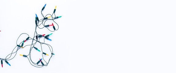 Garland of multi-colored light bulbs on a white background. Top view, flat lay. Banner