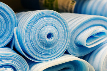 Heat-insulating material from the made foam polyethylene in big rolls. Trade in building materials in the store. Close-up. selective focus