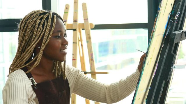 Young african student with septum nose piercing at the art studio