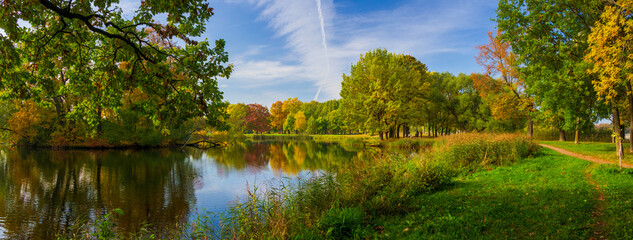 Large-format panorama in an autumn park with a lake and colorful foliage