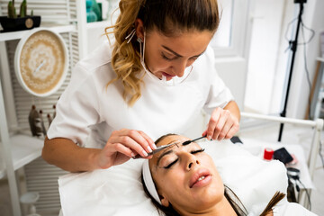 Woman Eye with Long Eyelashes. Beautiful Young Woman During Eyelash Extension.