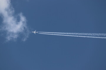A jet in the sky with track behind
