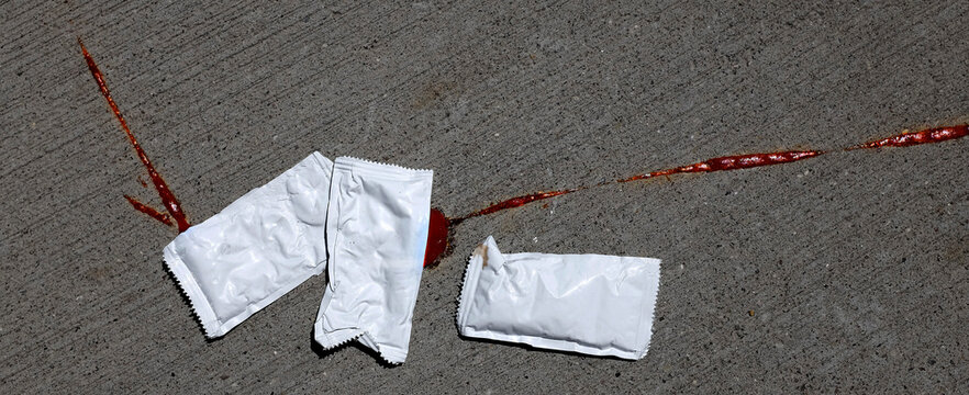 Squished Ketchup Catsup Packet On Sidewalk