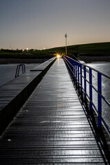Fototapeta premium Copenhagen, Denmark The boardwalk to the Kastrup Sea bath at night on the Oresund.
