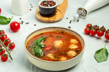 meatball tomato soup and vegetables on a light background. banner, menu, recipe place for text, top view - obrazy, fototapety, plakaty