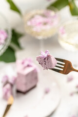 a piece of mousse cake, Delicious dessert blueberry tart with fresh berries with a bouquet of purple blooming lilacs, place for text