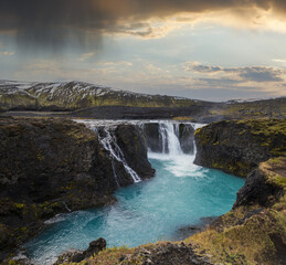 Obraz premium Picturesque waterfall Sigoldufoss autumn view. Season changing in southern Highlands of Iceland.