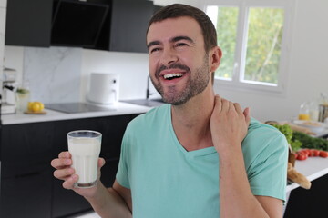 Man drinking milk in the kitchen