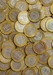 Coins of the state of Kazakhstan close-up. Kazakhstani coins of 200 and 100 tenge on a banknote. The concept of banking and inflation.