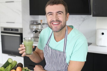 Man preparing a green juice with natural ingredients 