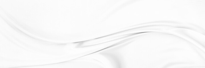 White gray satin texture that is white silver fabric silk panorama background with beautiful soft blur pattern natural.