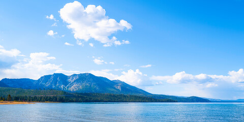 Tranquil Lake Tahoe with serene water reflections and dramatic clouds over Baldwin Beach near...