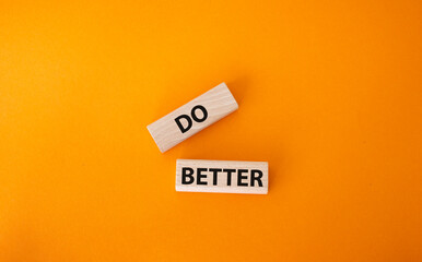 Do better symbol. Wooden blocks with words Do better. Beautiful orange background. Business and Do better concept. Copy space.