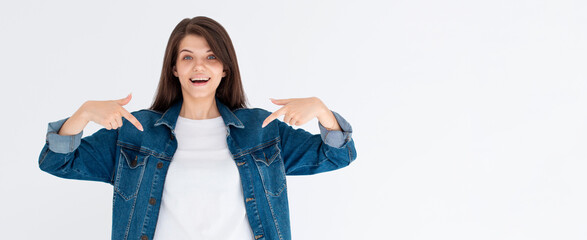 Excited brunette woman checking out awesome news, pointing fingers down and staring amazed, showing advertisement on bottom copy space, standing against white background