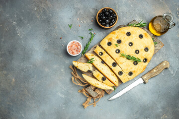 Italian traditional focaccia bread baking with rosemary, black olives and oil. banner, menu, recipe...