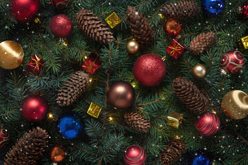 Obraz na płótnie Canvas Christmas holiday background with Christmas decorations and fir tree branches with cones. Top view, close up