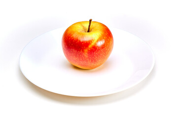 Insulated red juicy apple on a white plate on a white background
