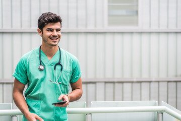 Male doctor using smartphone outdoors