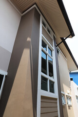 Exterior of modern house with window, roof and ceiling and rain gutter.