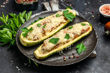 Zucchini stuffed with minced meat and cheese on a dark background. Food recipe background. Close up