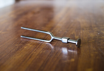 Metallic tuning fork on the table 