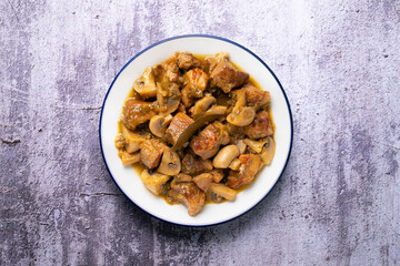 Braised pork with red wine sauce and mushrooms. Traditional northern Spanish tapas.