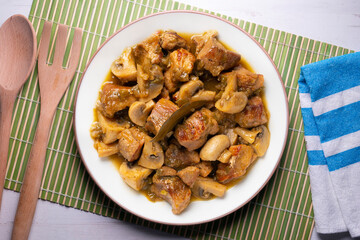 Braised pork with red wine sauce and mushrooms. Traditional northern Spanish tapas.