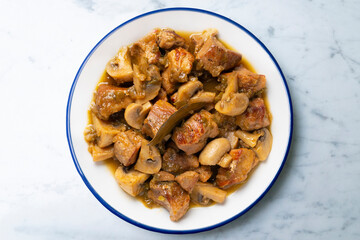 Braised pork with red wine sauce and mushrooms. Traditional northern Spanish tapas.