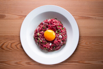Traditional steak tartare with beef and egg yolk.