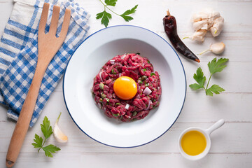 Traditional steak tartare with beef and egg yolk.