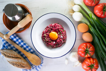 Traditional steak tartare with beef and egg yolk.