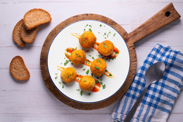 Tapa of Iberian ham croquettes. Recipe made with bechamel sauce and ham, all battered and fried in the shape of round balls.