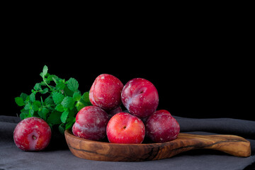 Fresh purple plum  on black background