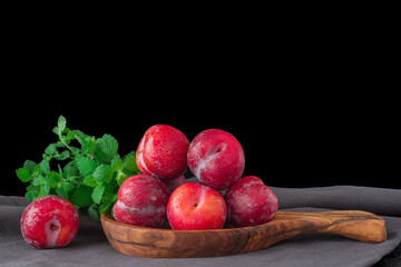 Fresh purple plum  on black background