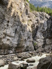 Canyon in Switzerland Europe Grindelwald. Big rocky canyon in Switzerland with river on the bottom and waterfalls. Switzerland landscape in the summer sunny day. Nature canyon landscape with the trees