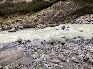 Canyon in Switzerland Europe Grindelwald. Big rocky canyon in Switzerland with river on the bottom and waterfalls. Switzerland landscape in the summer sunny day. Nature canyon landscape with the trees