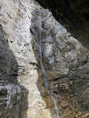 Canyon in Switzerland Europe Grindelwald. Big rocky canyon in Switzerland with river on the bottom and waterfalls. Switzerland landscape in the summer sunny day. Nature canyon landscape with the trees