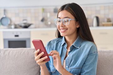 Young asian woman using mobile phone for chatting in social media network