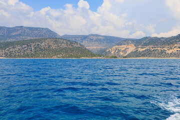 Fototapeta premium View of the rocky shore from the sea. Mediterranean Sea in Turkey. Popular tourist places. Background