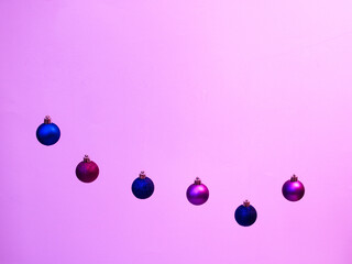 Christmas and New Year's colorful luminous  balls on a pink background.