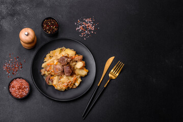 Delicious vegetable stew with beef, potatoes, carrots and cabbage in a black plate