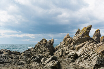 basalt rocks on the sea coast, Cape Stolbchaty on Kunashir Island