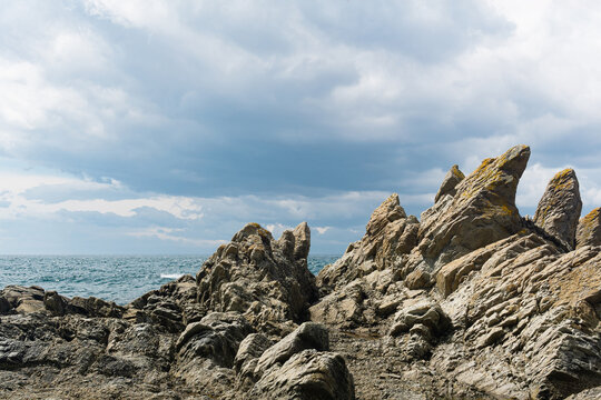 basalt rocks on the sea coast, Cape Stolbchaty on Kunashir Island