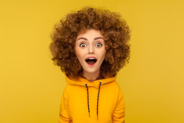 Wow, unbelievable. Comic portrait of shocked surprised funny woman with Afro hairstyle looking at...