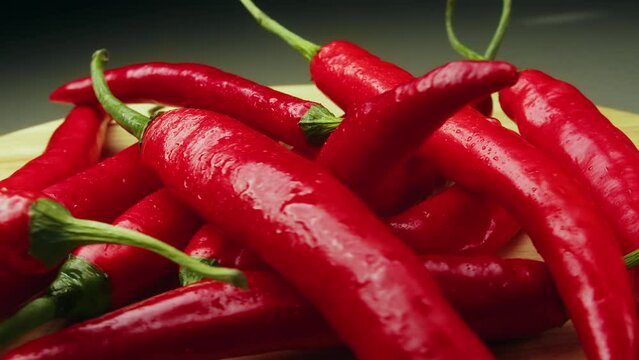 On wood plank Ripe red long hot chili peppers are the world's number one culinary delight and cash crop in New Mexico, USA, Vietnam, Thailand, Asia. They are a delightful part of world cuisine.