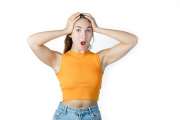 Fototapeta premium Portrait of surprised young woman with hands on face. Amazed young woman with opened mouth. Happiness and excitement concept