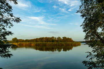 Fototapeta na wymiar Sunny spring morning on the river bank. Picturesque rural landscape. Summer sunny background.