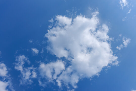 White fluffy clouds in a blue sky. High quality photo