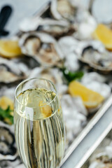 Oysters plate with lemon and champagne in restaurant. Oysters with lemon. vertical image. top view. place for text